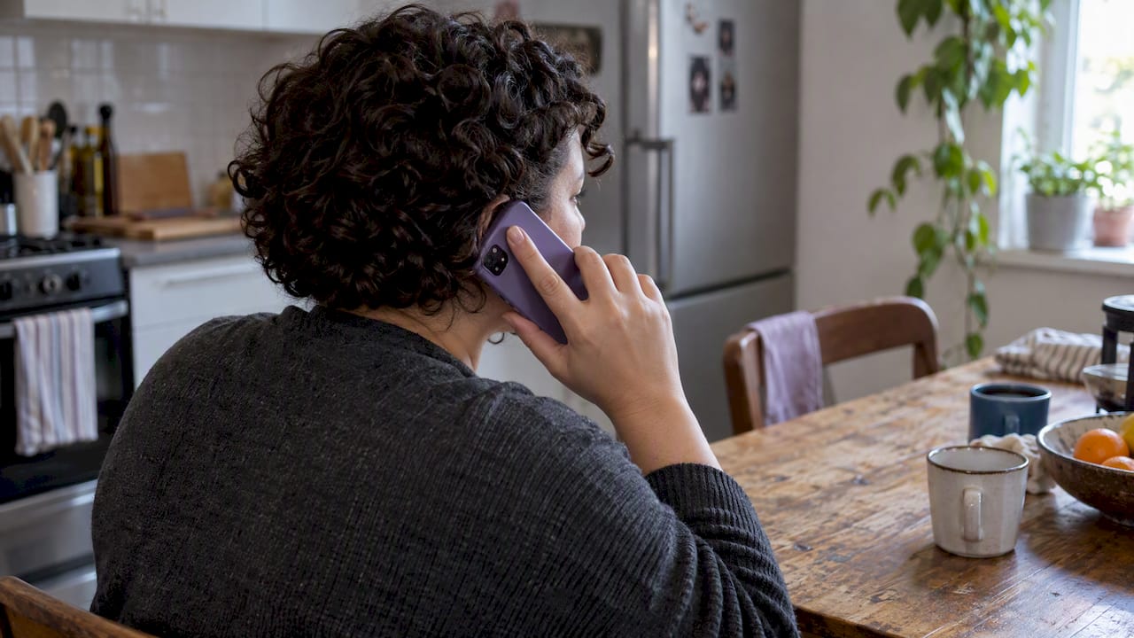 Shopper speaking with phone support at home